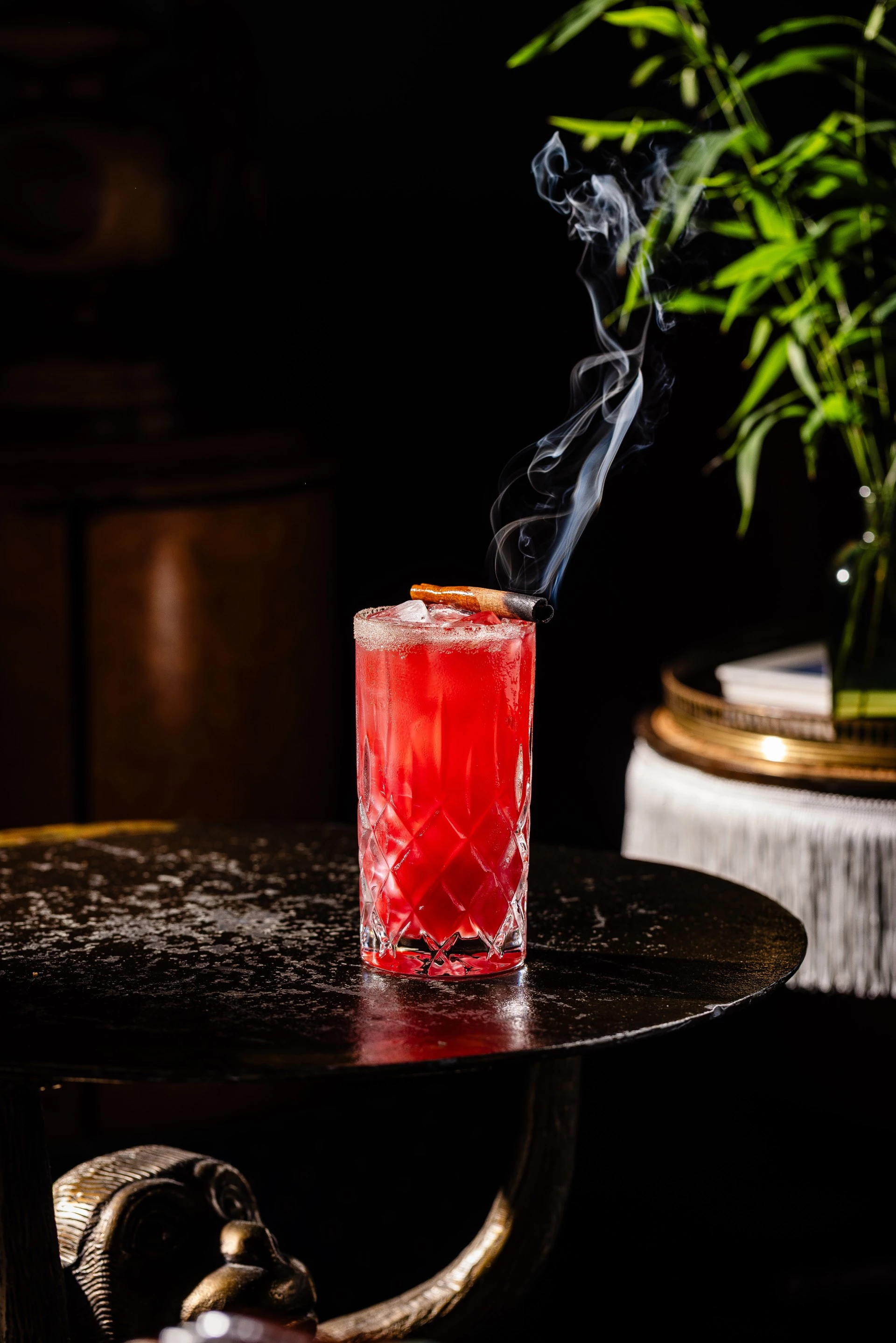 a glass with a drink and a cigar in it