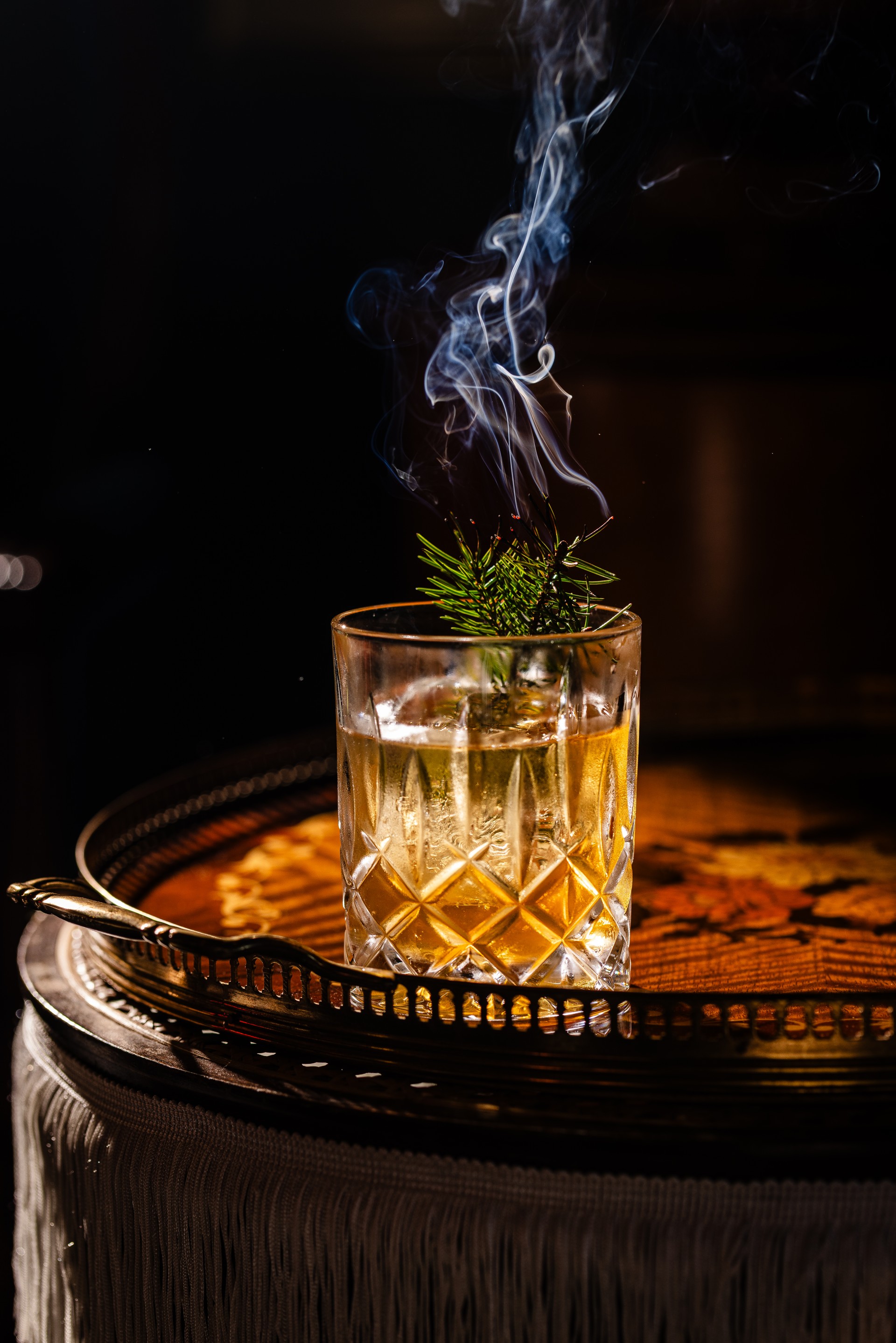 a glass with a drink and smoke