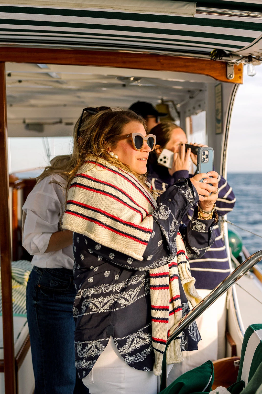 a group of people on a boat taking a picture of themselves