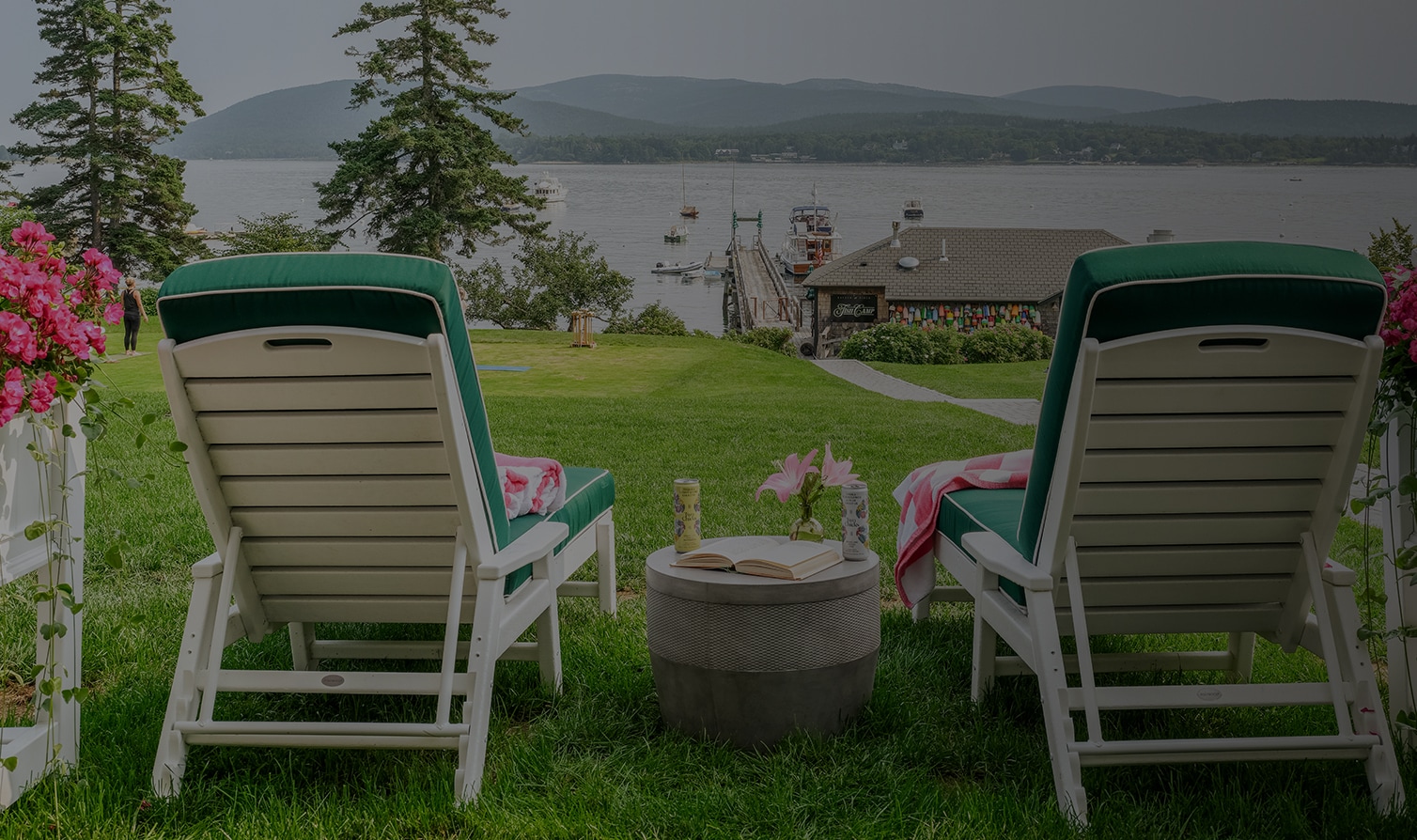 chairs on the grass by the water