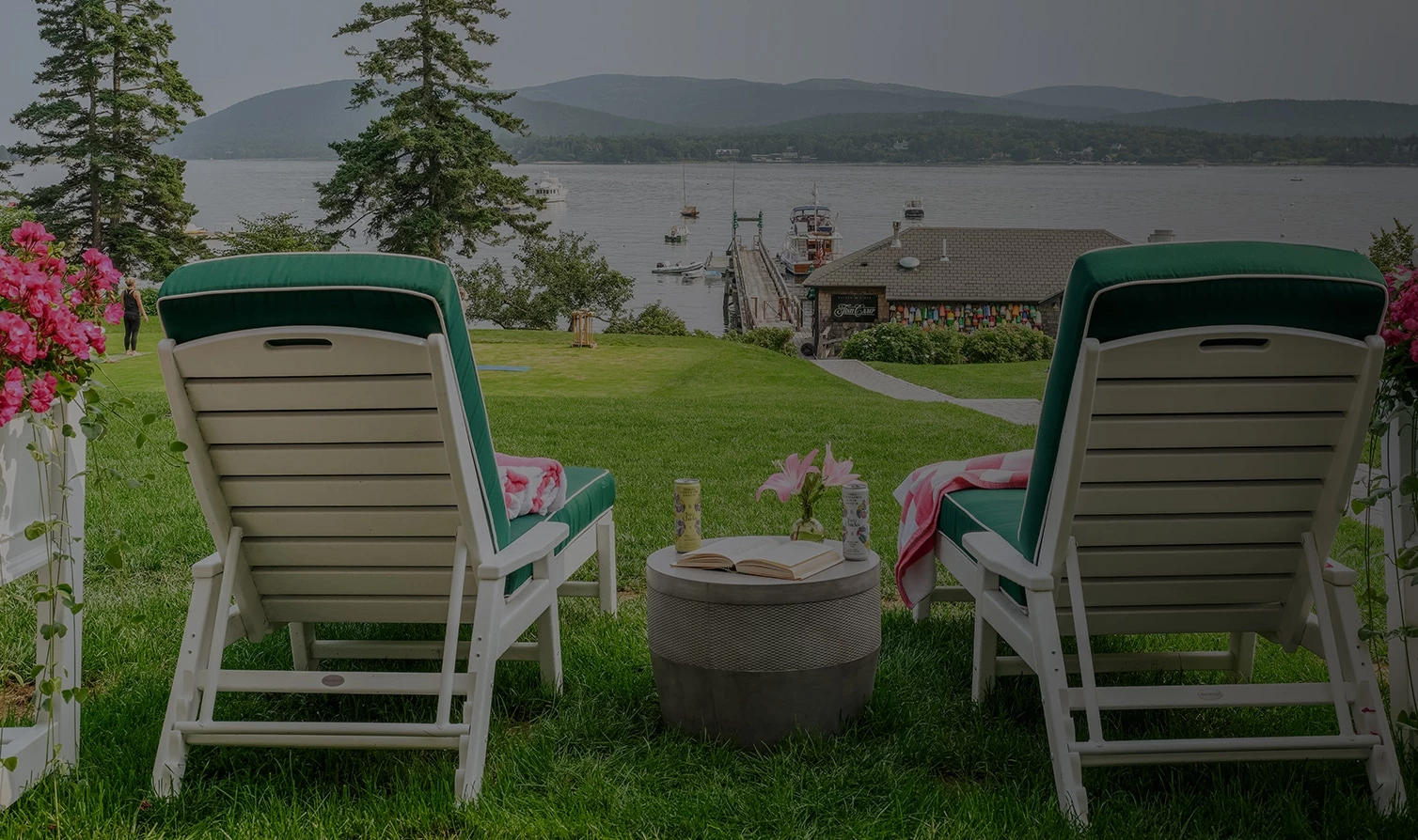 chairs on the grass by the water