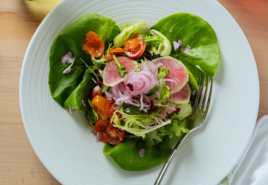a plate of salad with a fork