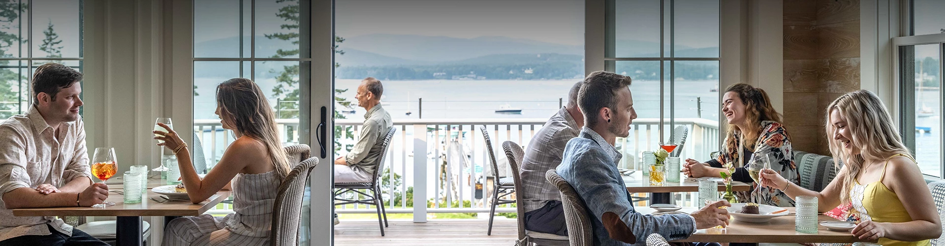 a group of men sitting on chairs looking out a window