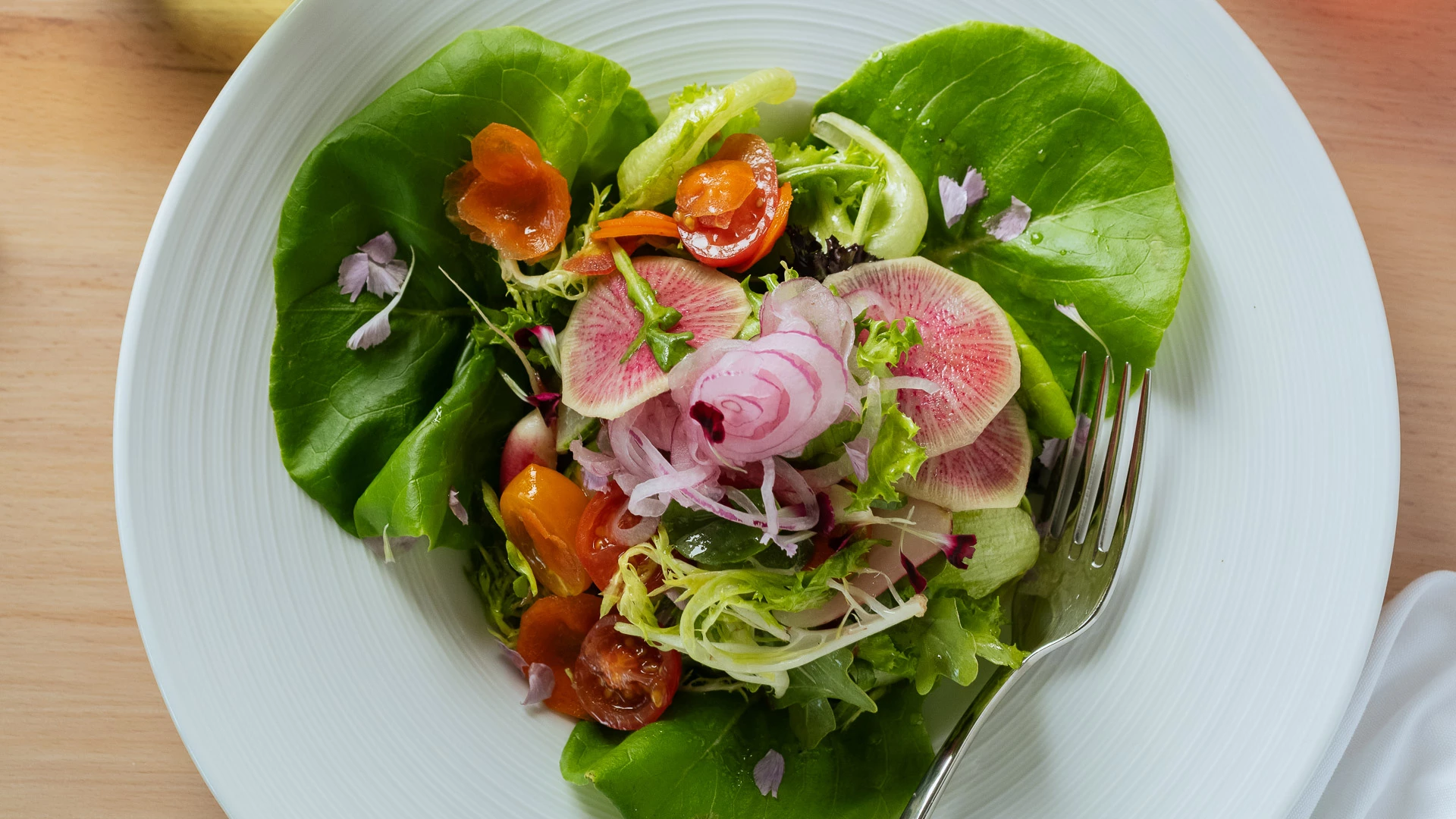 a salad with vegetables and a fork