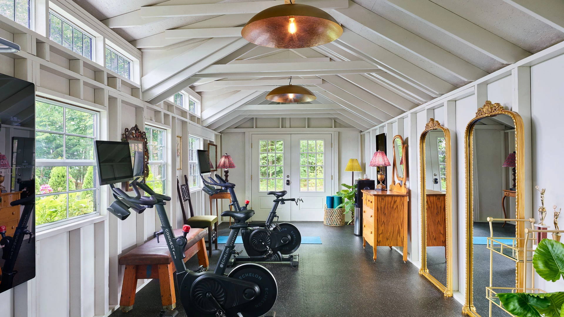 a room with exercise bikes and a mirror