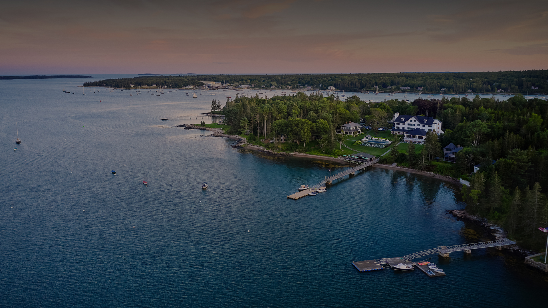 a body of water with a house and trees