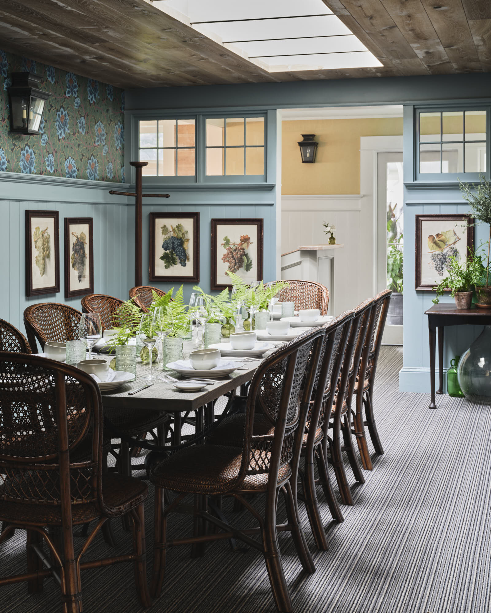 a dining room with a table set with plates and plates