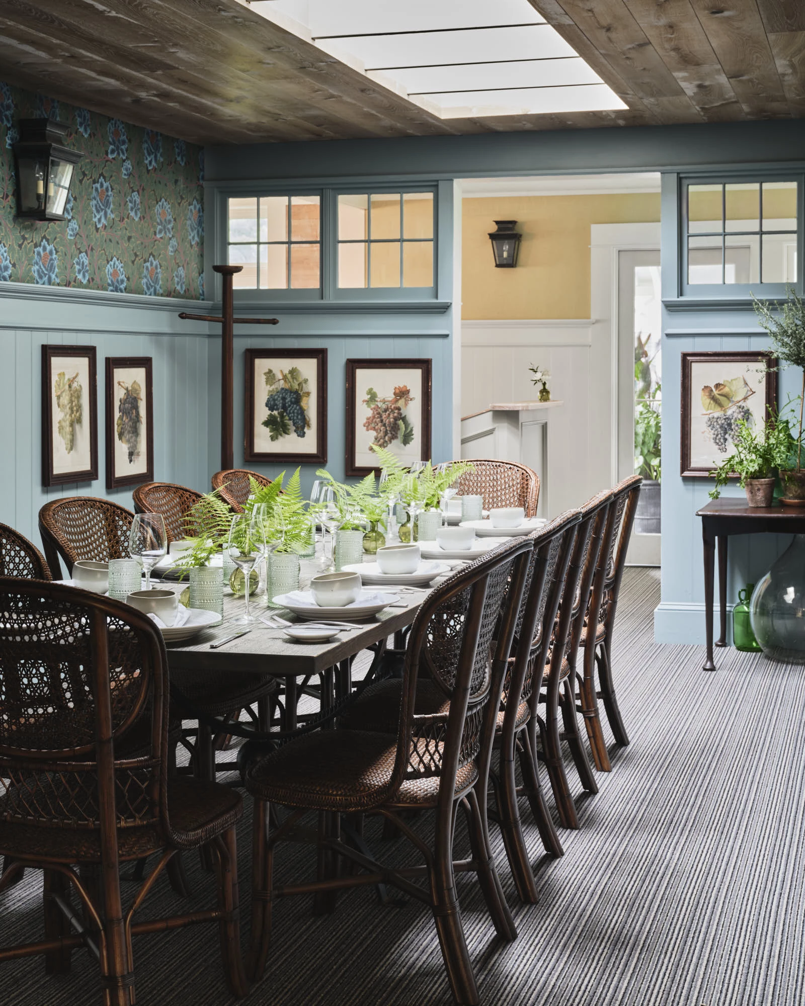 a dining room with a table set with plates and plates
