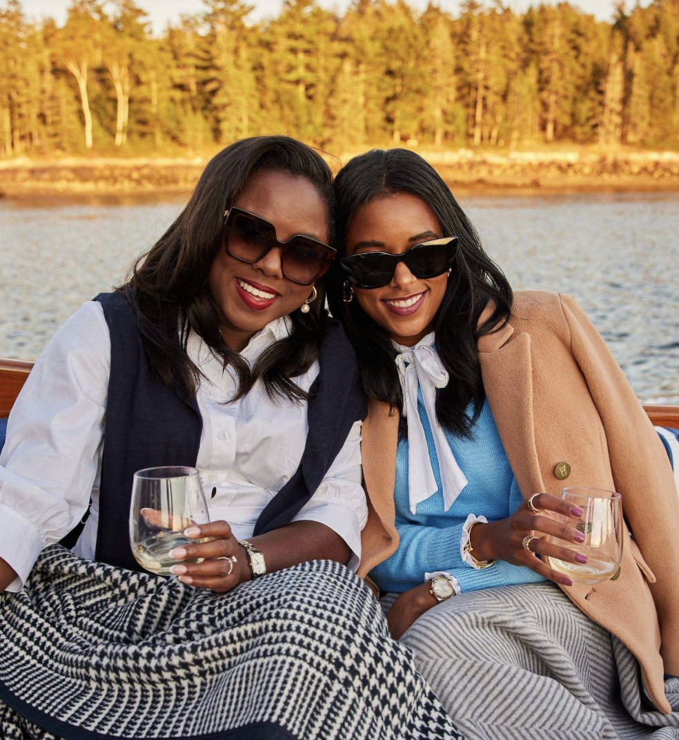 two women sitting on a boat