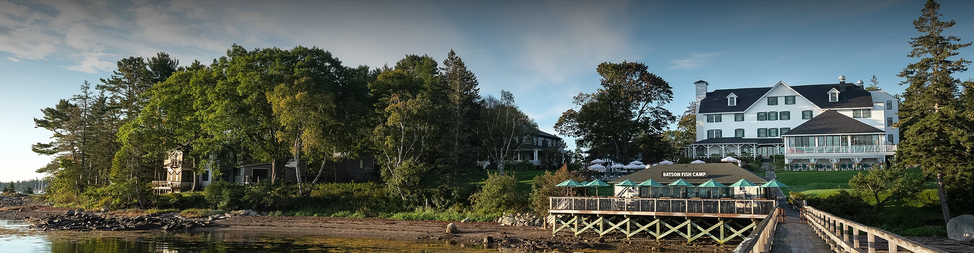 a dock with umbrellas on the side of the water