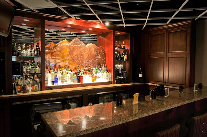 a bar with a display of bottles