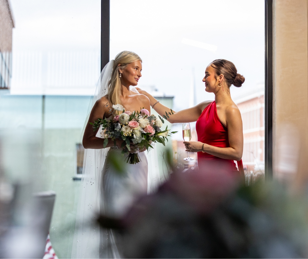 a woman in a white dress holding a bouquet of flowers