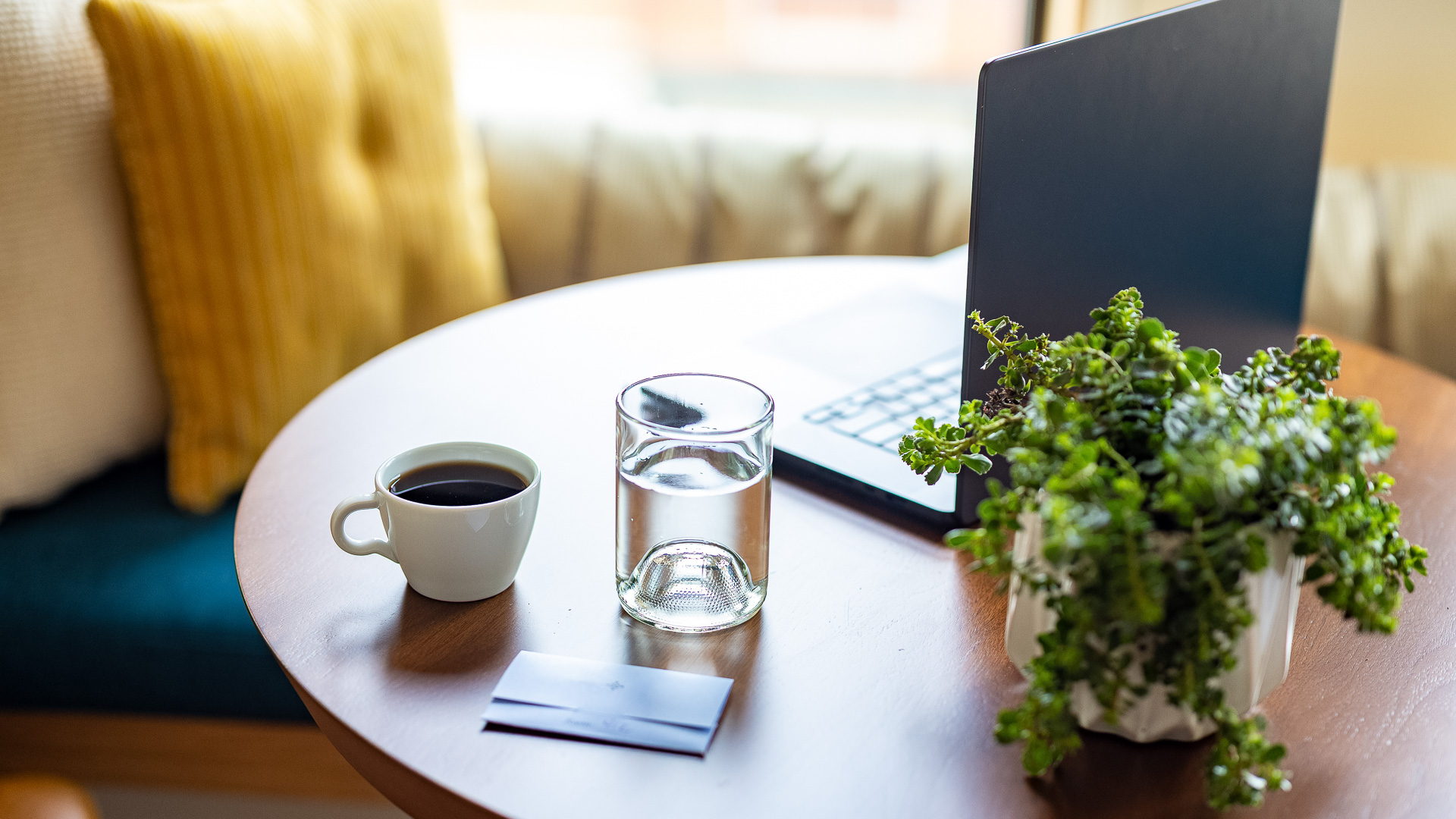 a cup of coffee and a laptop on a table