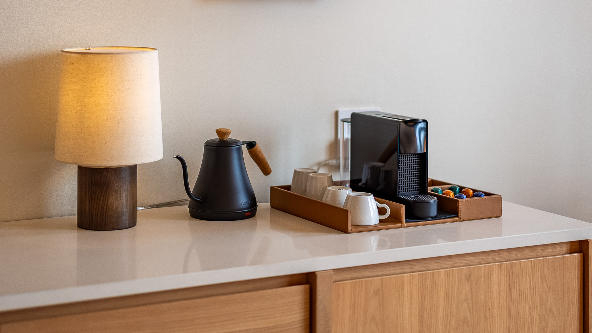 a coffee maker and mugs on a counter