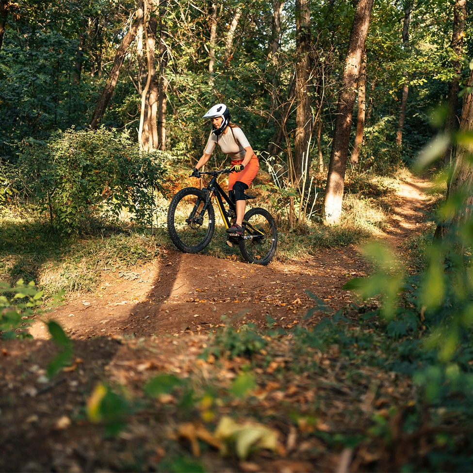 a person riding a bike in the woods
