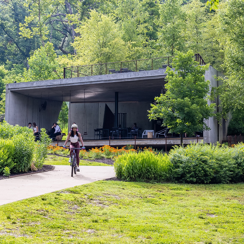 a woman riding a bicycle in a park