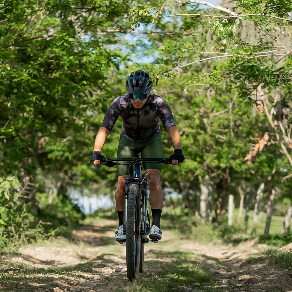 a man riding a bike on a dirt path