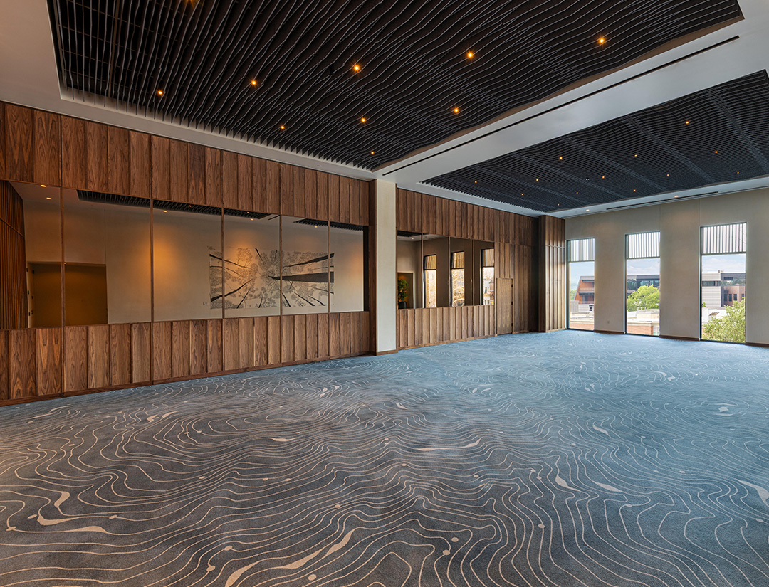 a room with wood cabinets and a patterned carpet