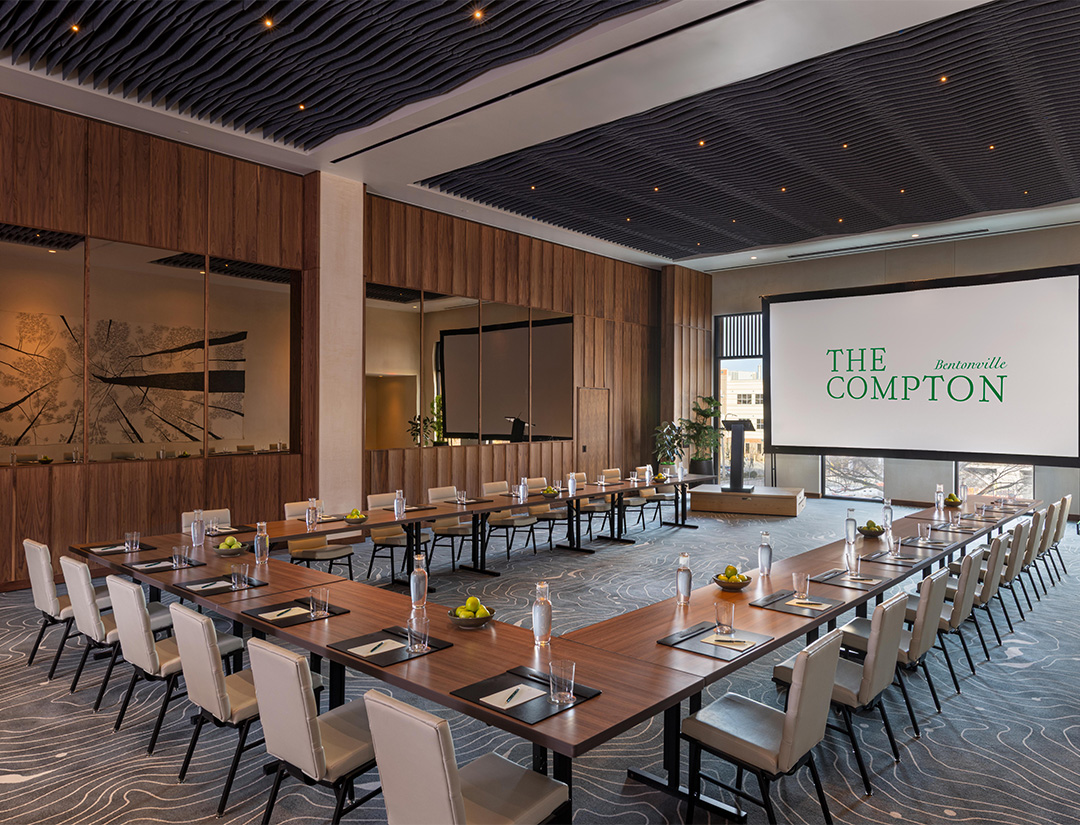 a large conference room with a projector screen