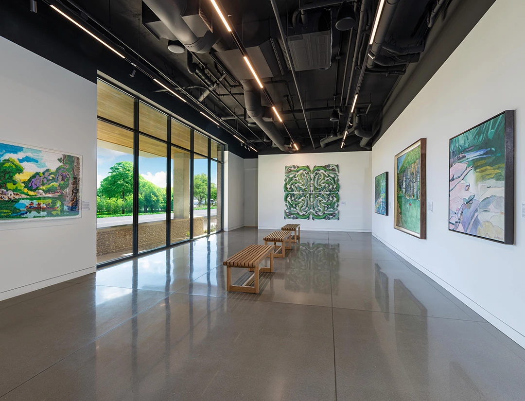 a room with benches and paintings on the wall