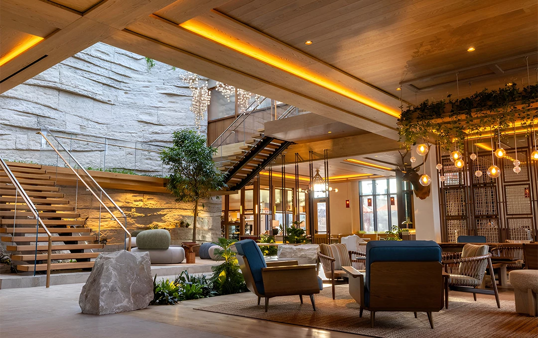 a room with a large stone staircase and chairs