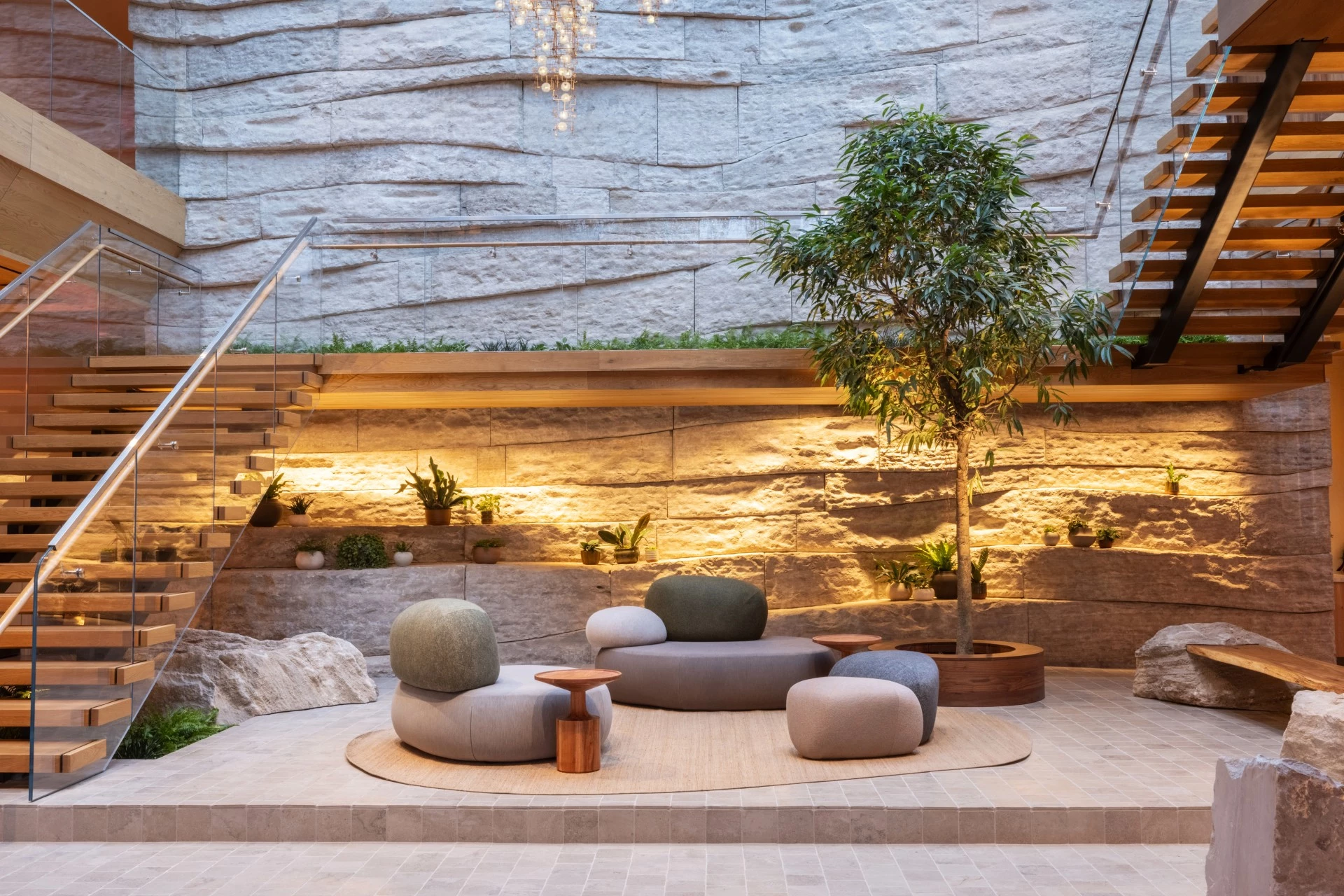 a patio with a round couch and a tree