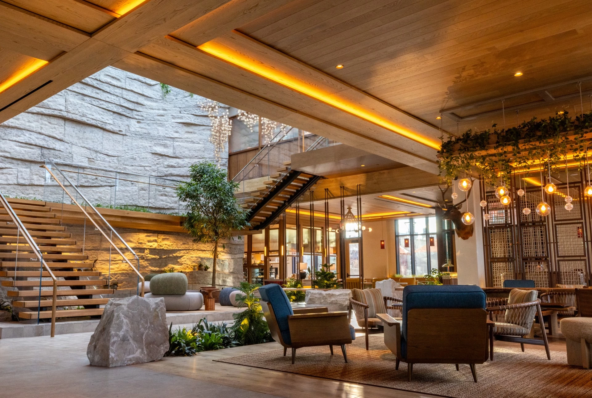 a room with a large stone wall and a large staircase