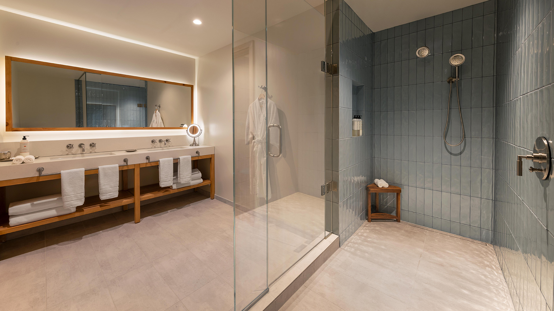 a bathroom with a glass shower and a sink