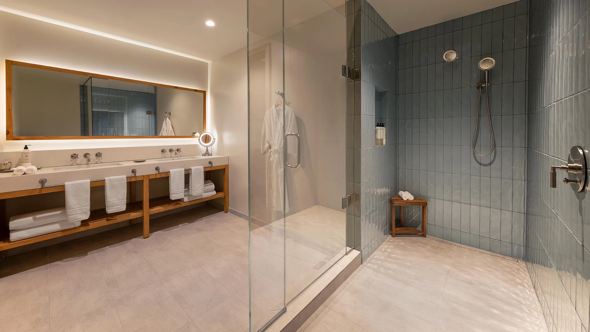 a bathroom with a glass shower and a sink