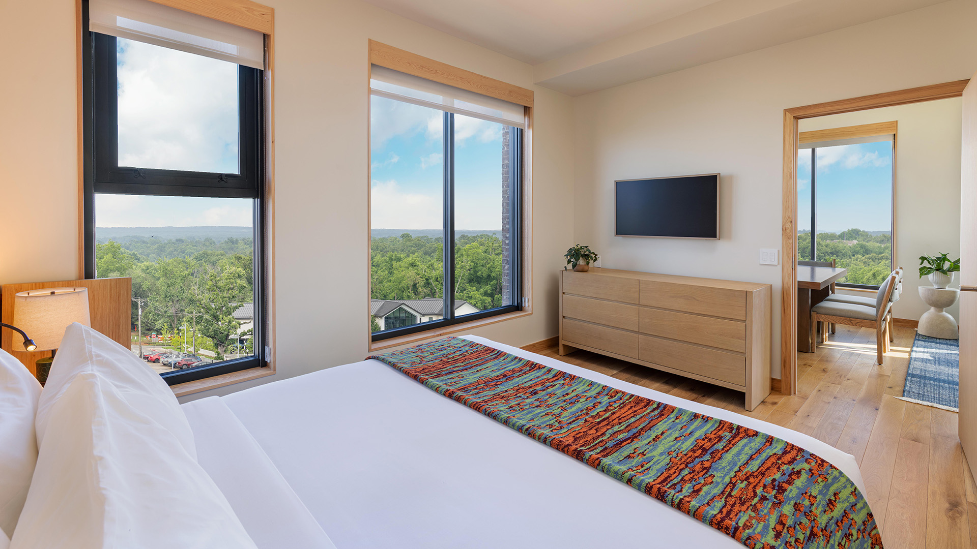 a bedroom with a large window and a bed