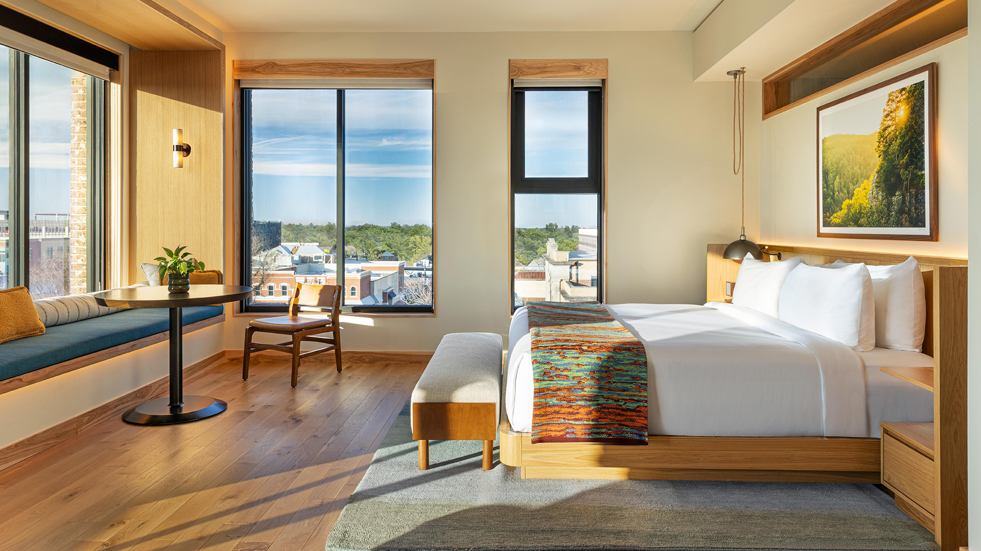 a room with a bed and a chair and a table