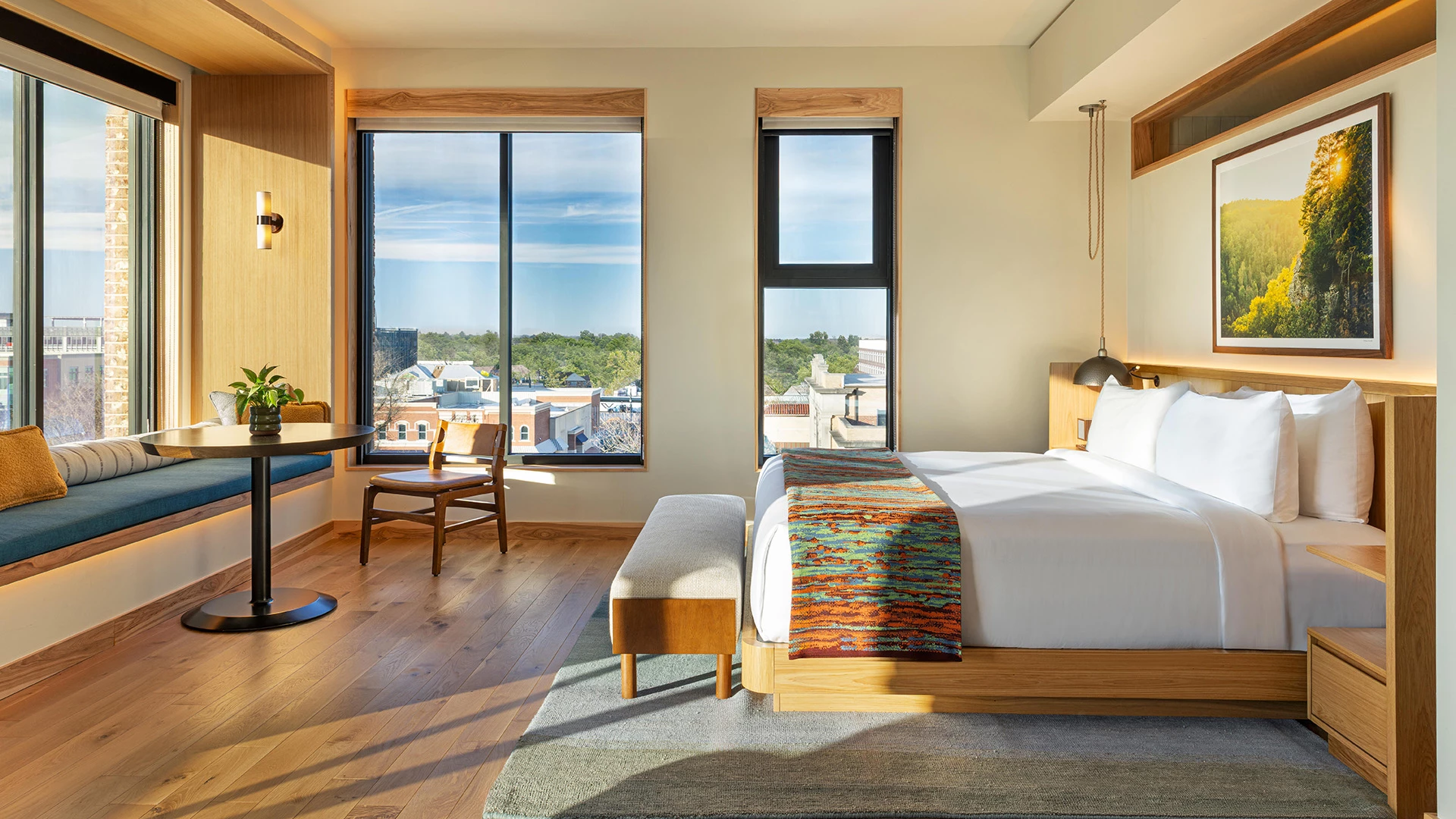 a room with a bed and a chair and a table