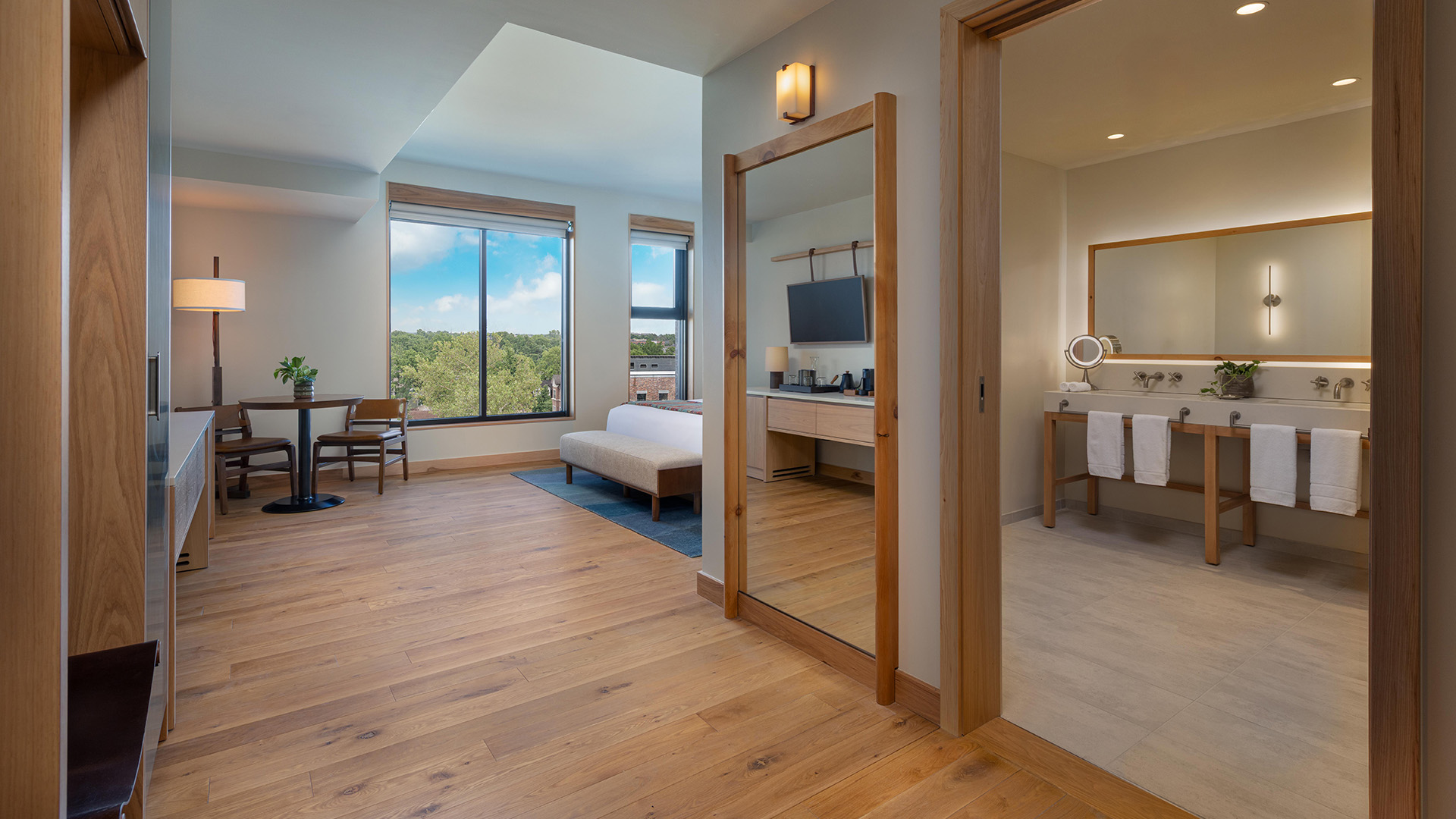 a room with a mirror and a bed and a mirror