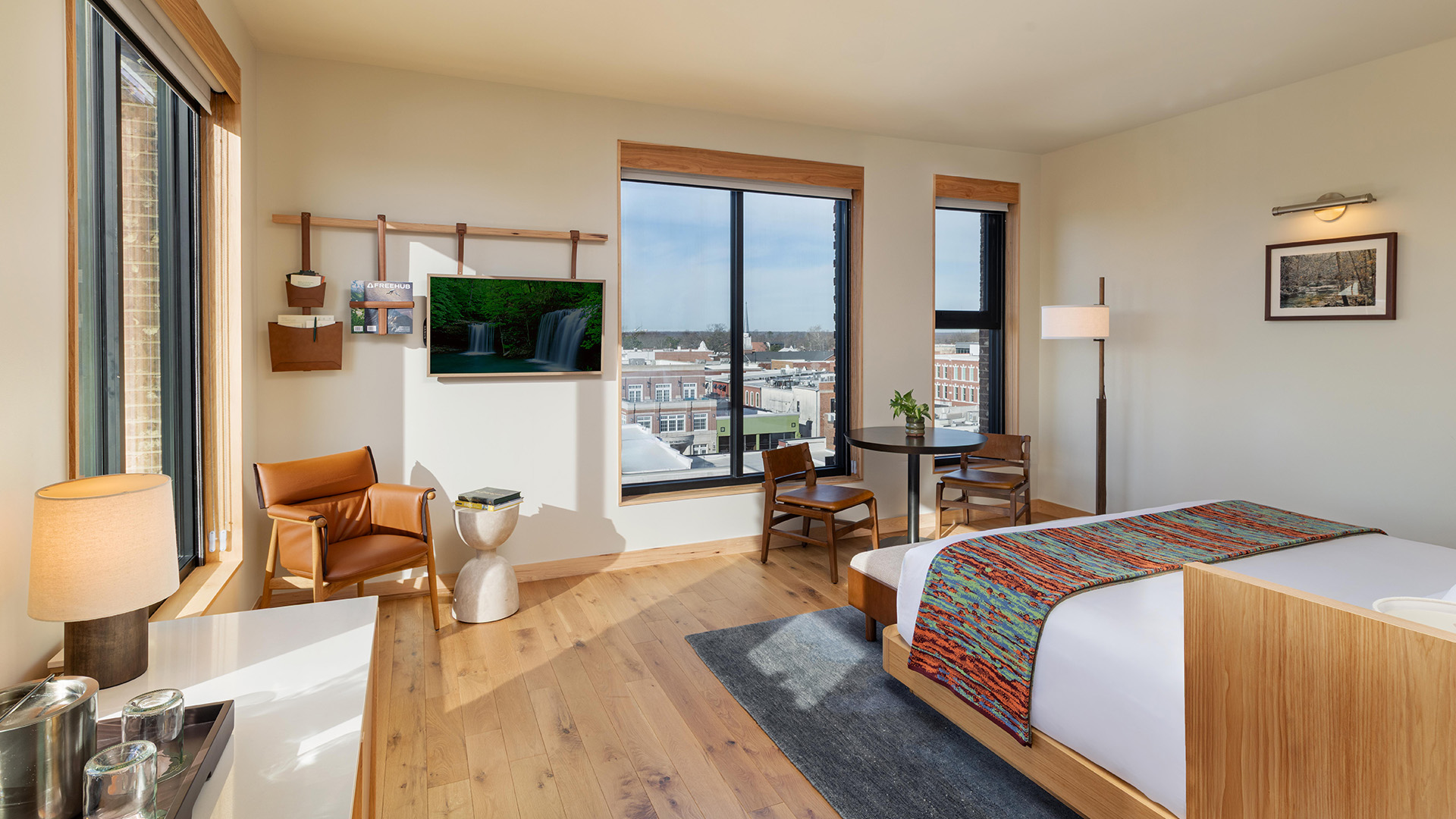 a room with a bed and a table and chairs