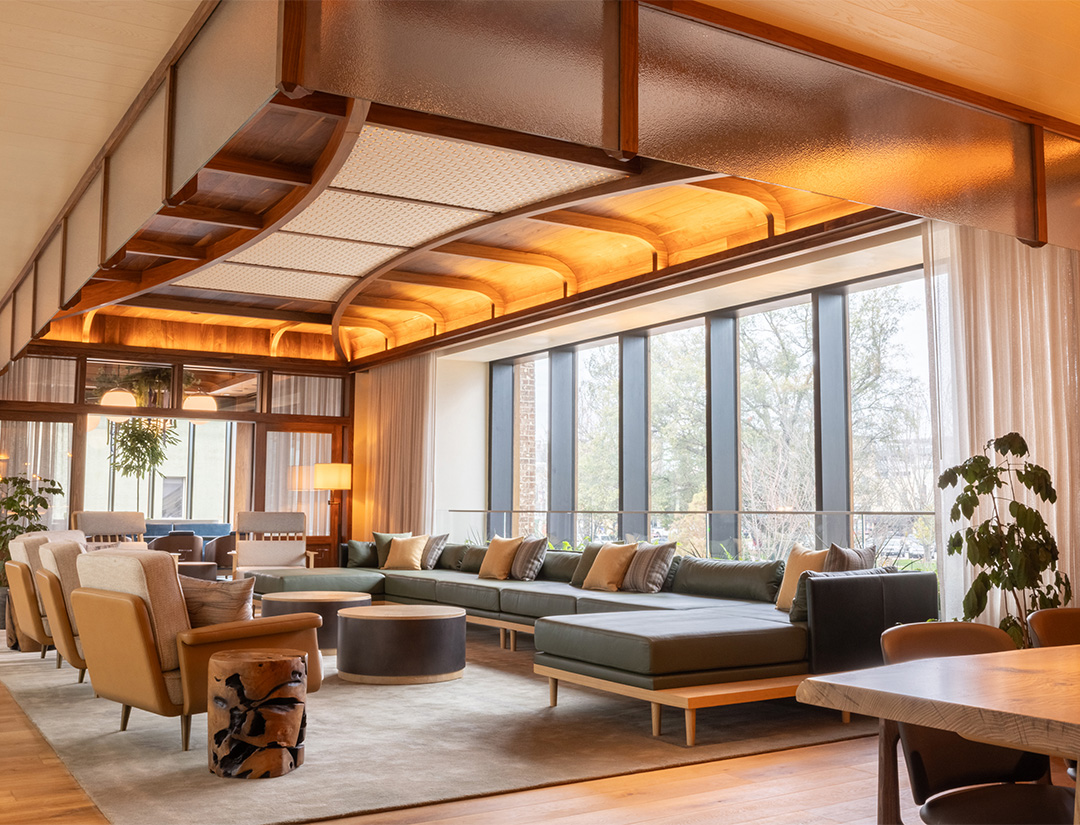 a room with a large couch and chairs