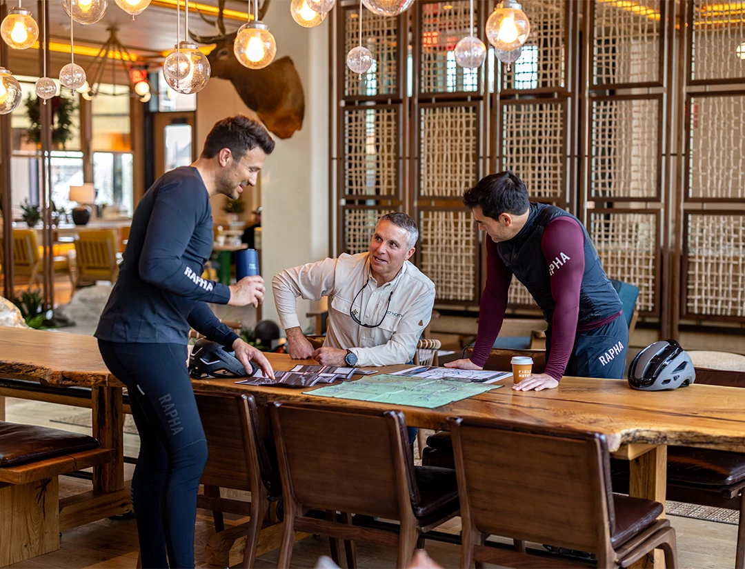 a group of men standing around a table