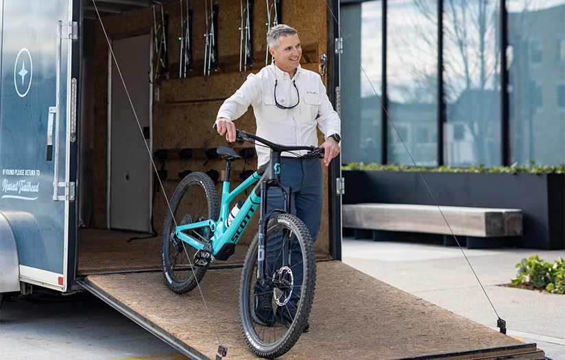 a man standing next to a bicycle