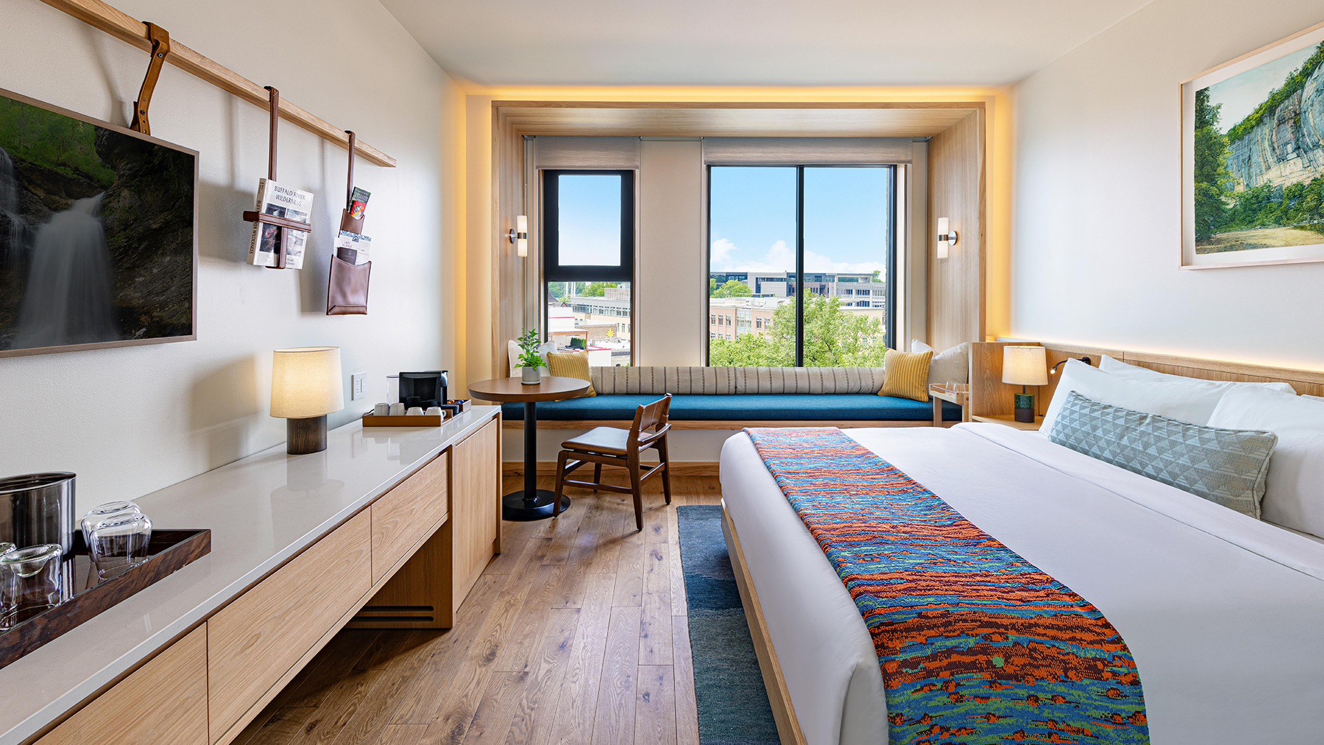 a room with a bed and a table and chairs