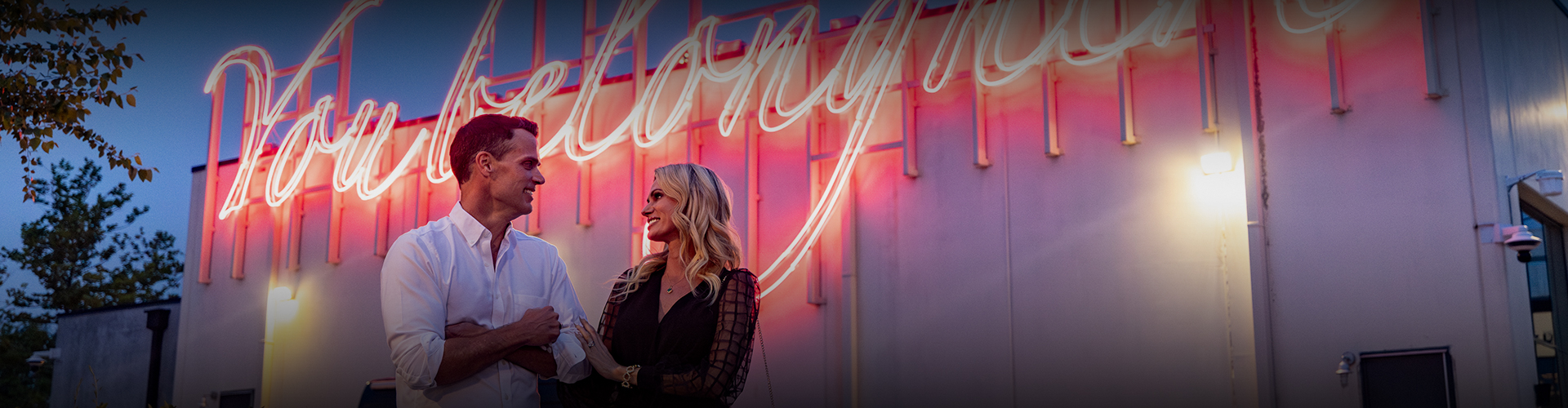 a woman holding a paper and smiling