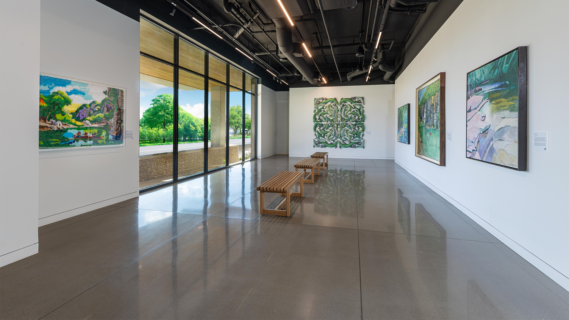 a room with benches and paintings on the wall