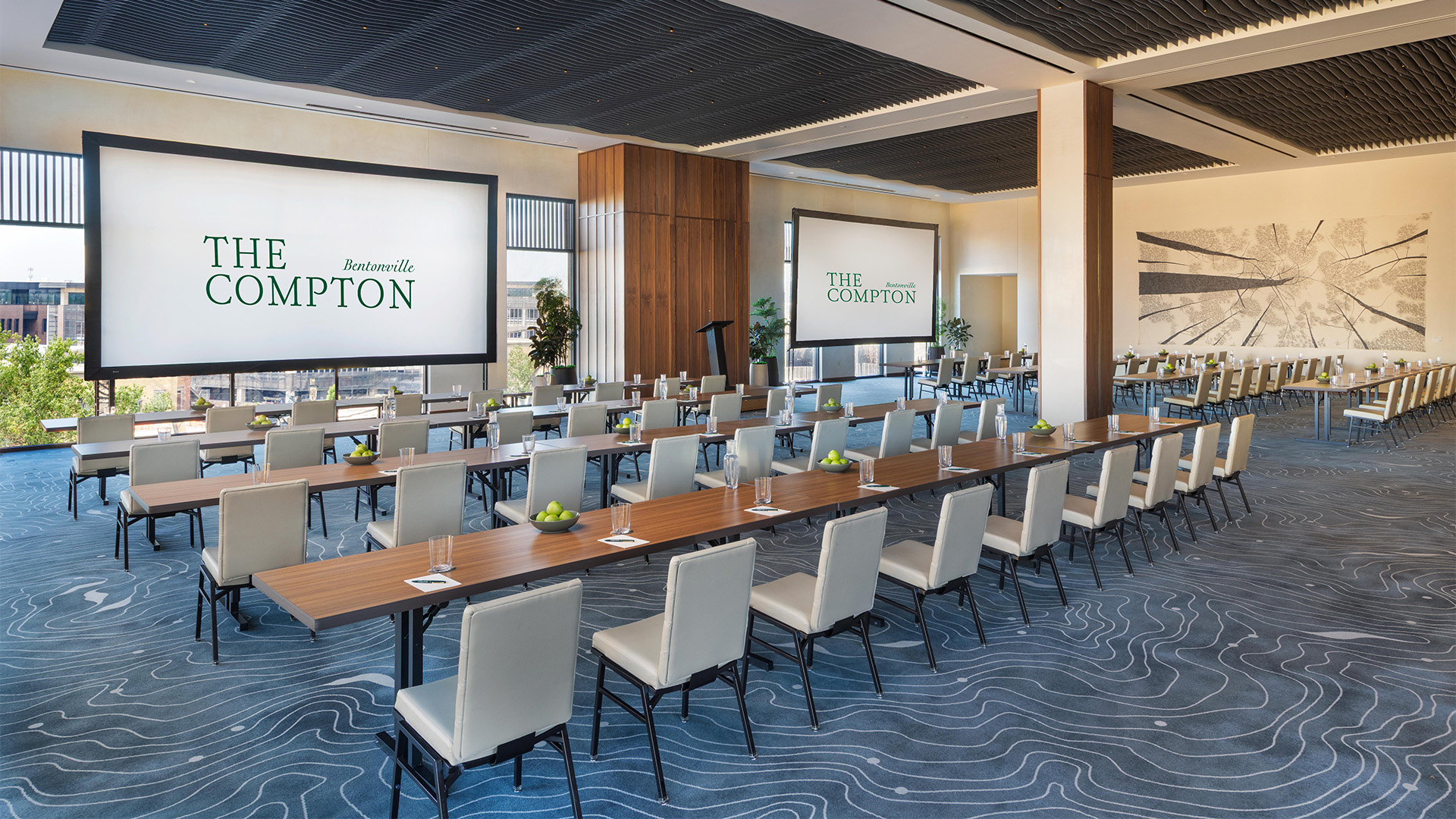 a room with long tables and chairs