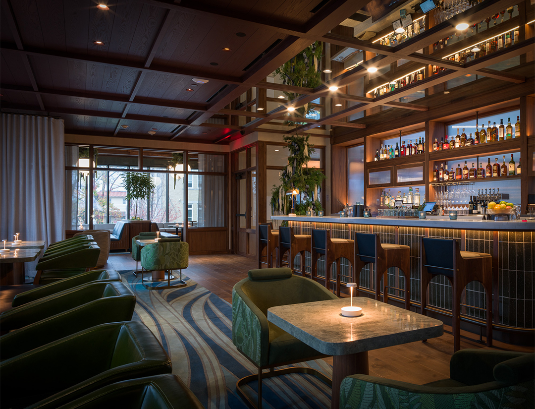 a room with a bar and chairs