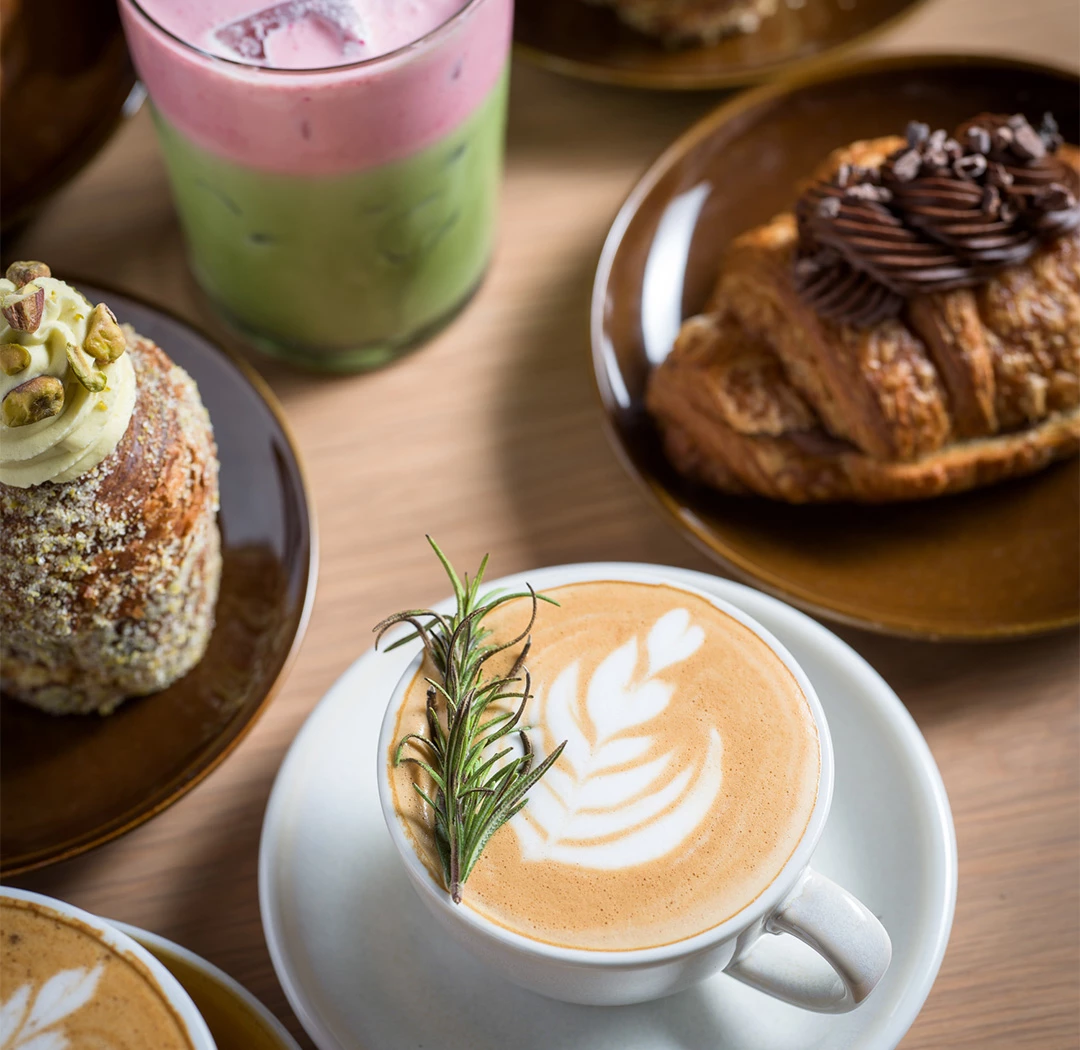 a cup of coffee and pastries on plates