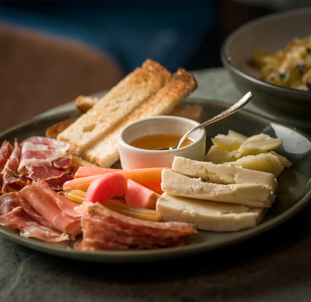 a plate of food with a spoon and a bowl of food