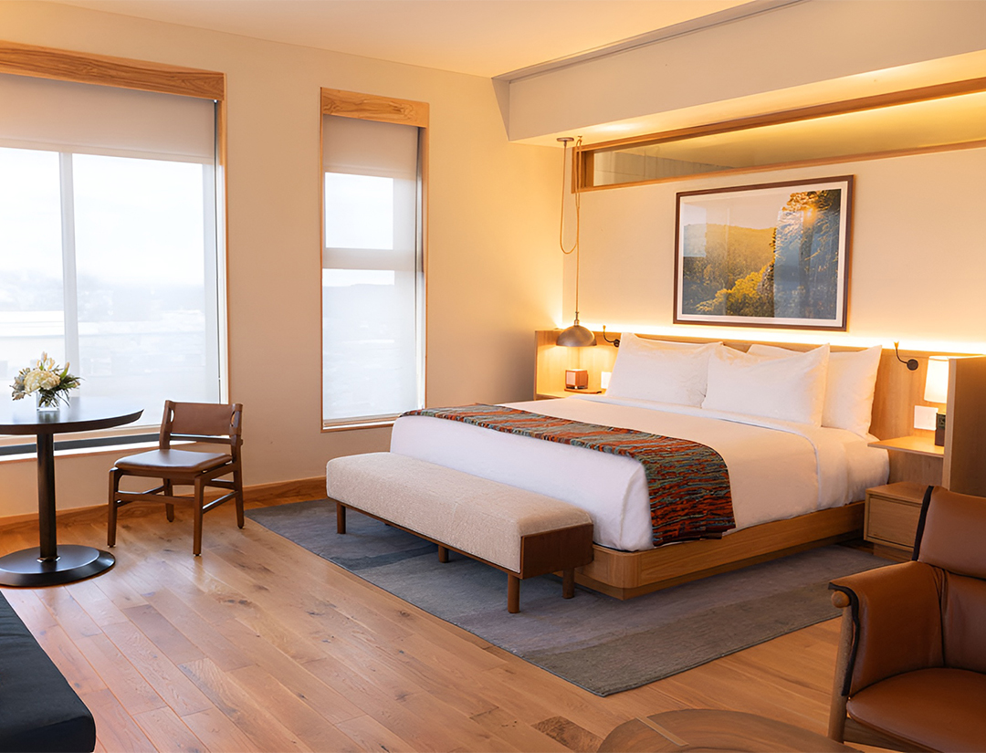 a bedroom with a bed and chairs