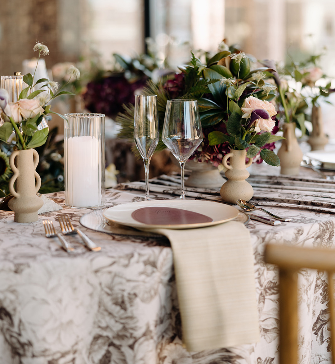 a table set with flowers and candles
