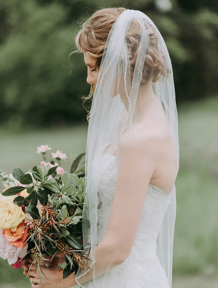 a woman in a wedding dress with a bouquet of flowers