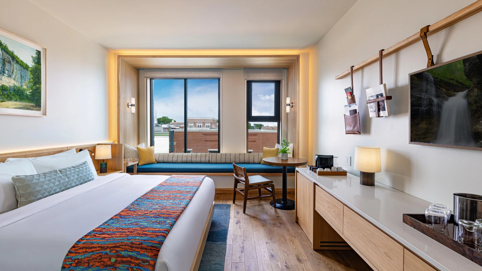 a room with a bed and a table and chairs