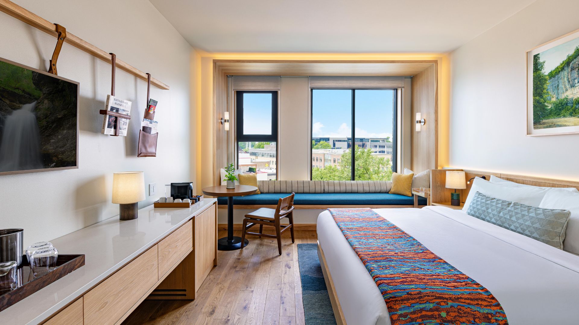 a room with a bed and a table and chairs