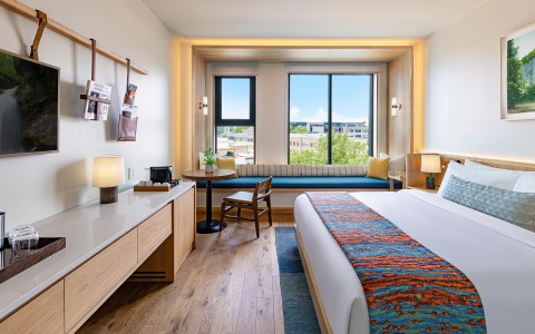 a room with a bed and a table and chairs